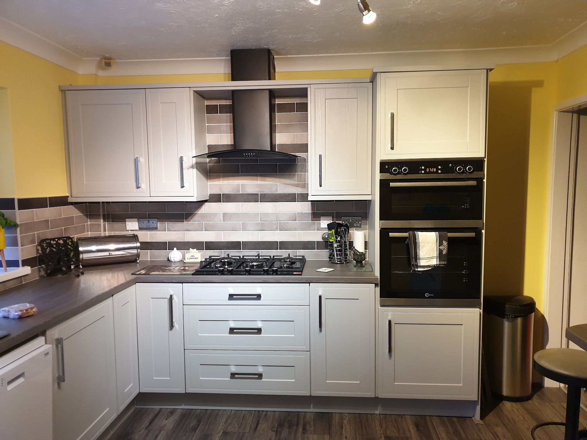 Light grey shaker kitchen with a double oven housing and gas hob