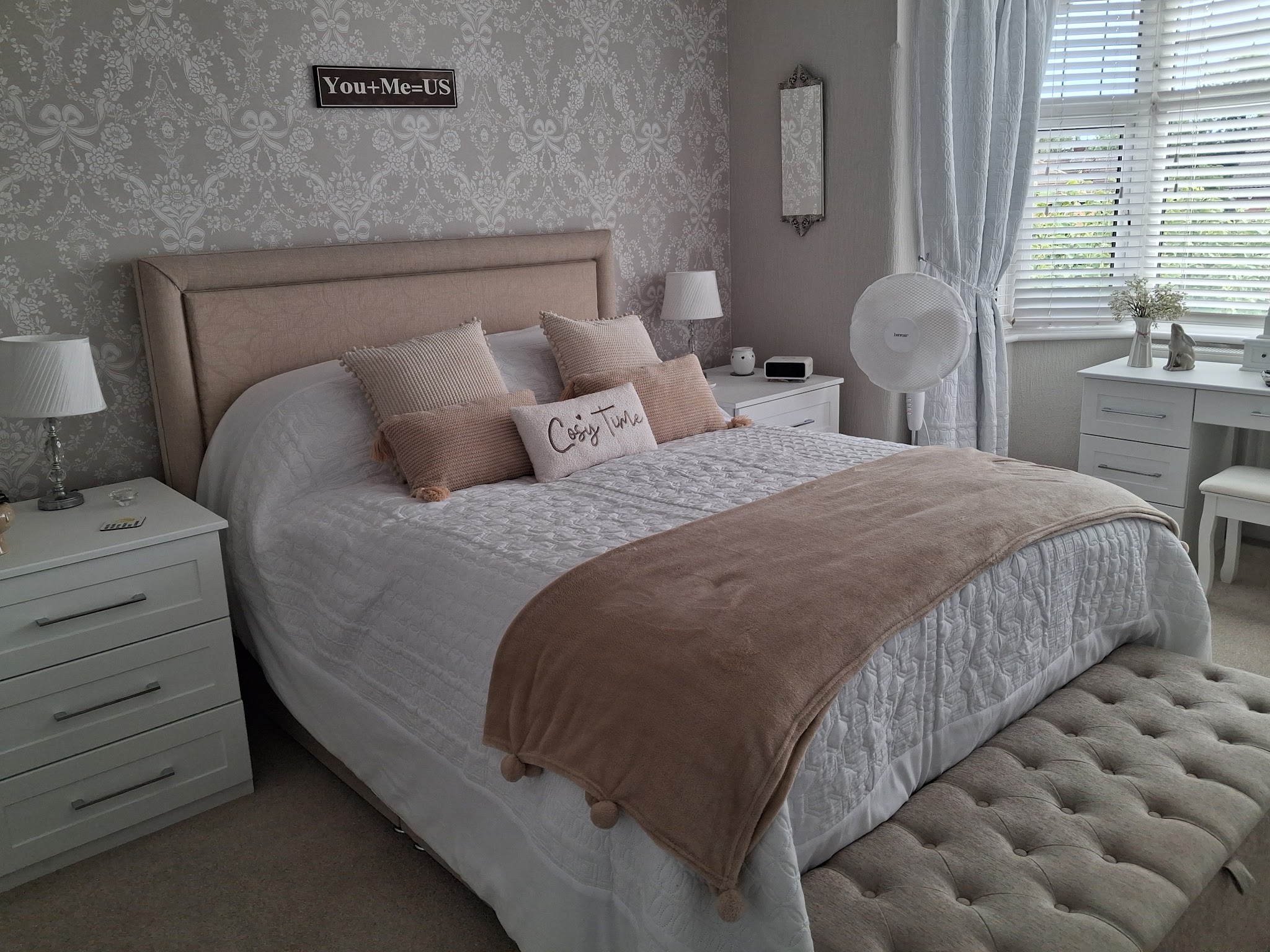 Bedroom with white bedside drawers and a matching dressing table